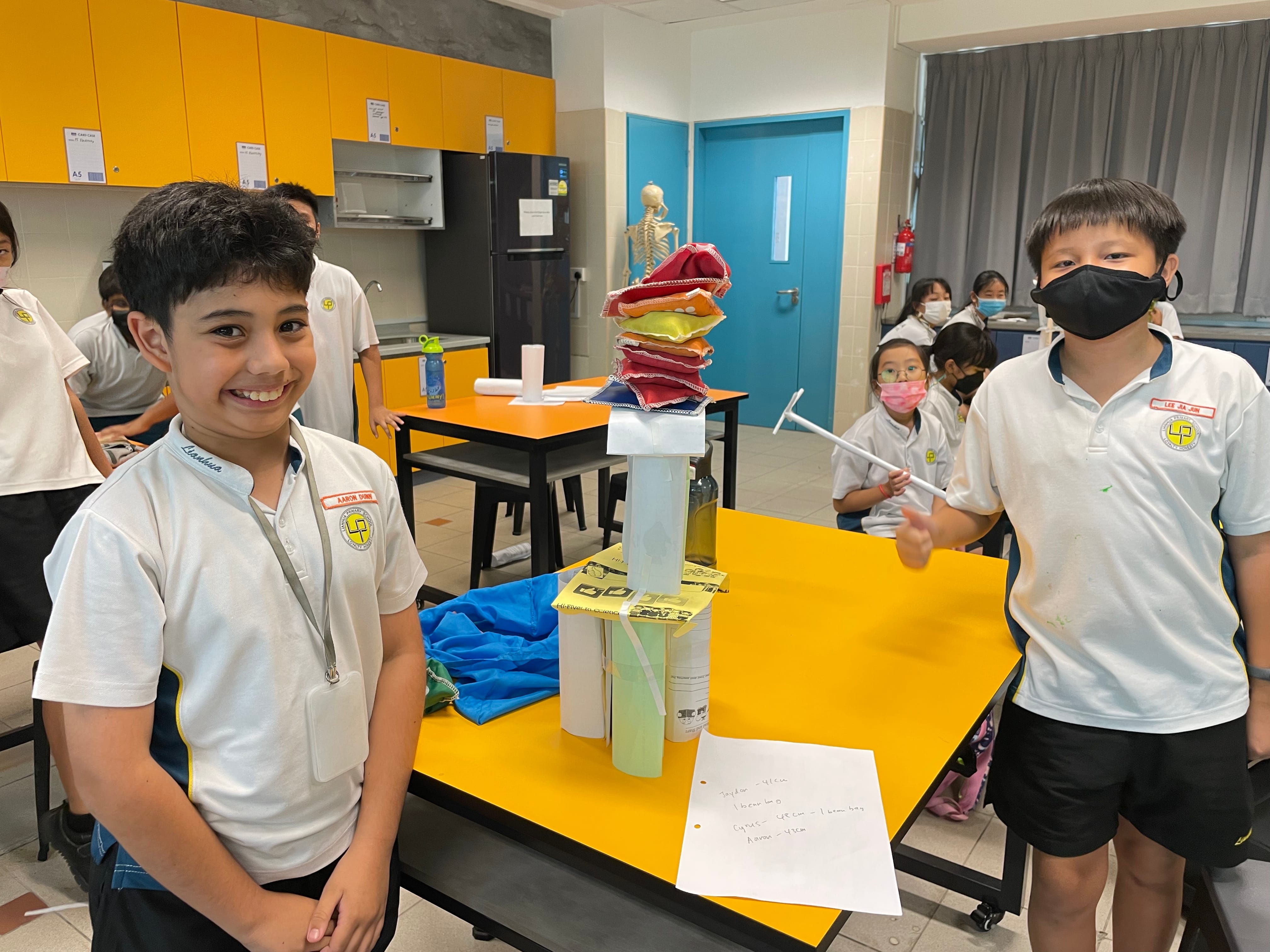 2 boys with their experiment work.